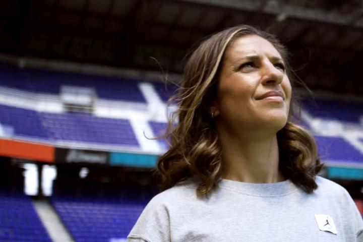 Close up of soccer legend Carli Lloyd standing in a soccer stadium