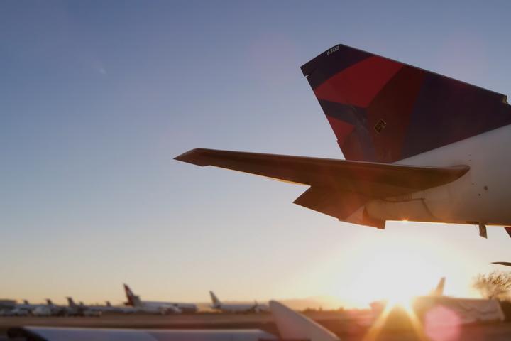Sun rising behind tail of Boeing 747